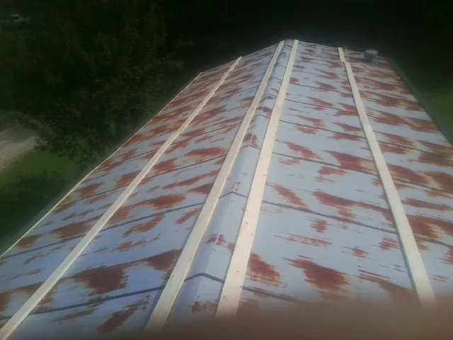Rusted metal roof panels with new wood purlins before replacement — Storm Damage Roof Repair in Fremont by Roofing Brothers